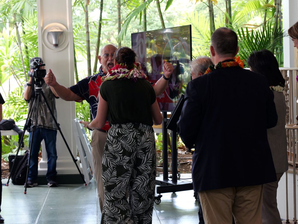 Keaʻau High School Principal Dean Cevallos congratulates J. Elise Hannigan after she was announced on Sept. 19, 2025 as Hawaiʻi State Teacher of the Year. (Photo Courtesy: Hawaiʻi State Department of Education)