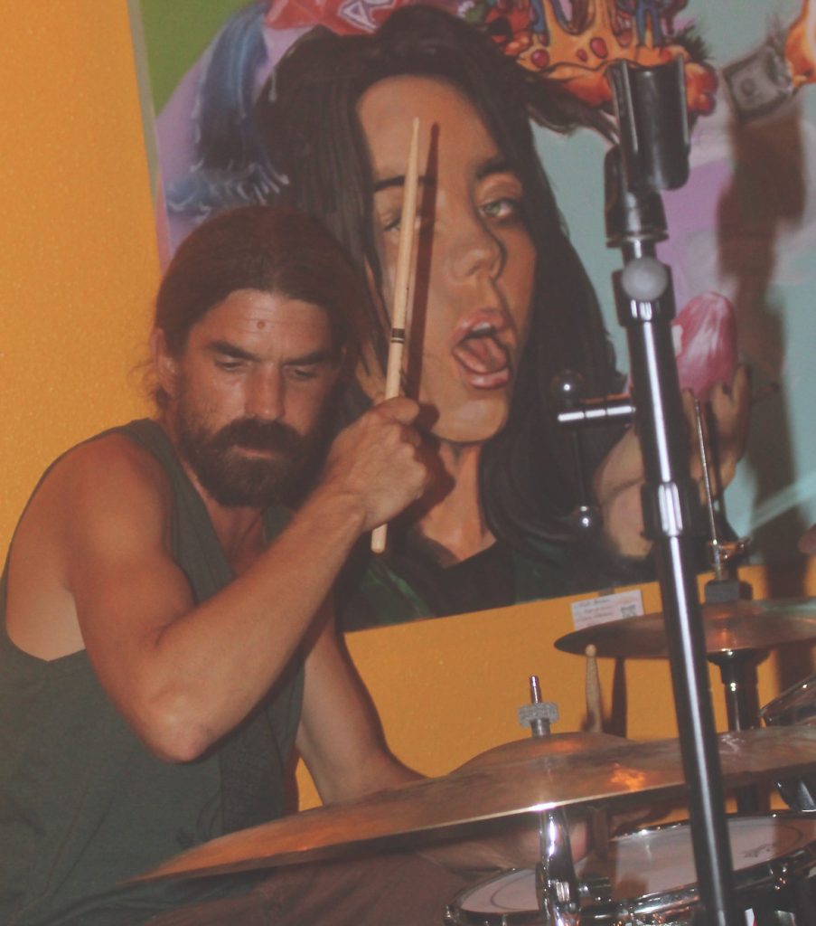 Jahred Darius, who manages the Rainbow Room, also plays several instruments and sings with PunaKat. (Photo Credit: Jeff Hansel)