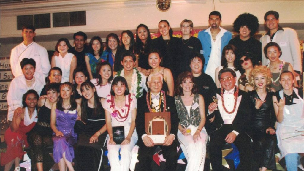 Chuck Yim Gee, front center with plaque, was the longtime dean of the University of Hawaiʻi's School of Travel Industry Management. (File photo: University of Hawaiʻi)