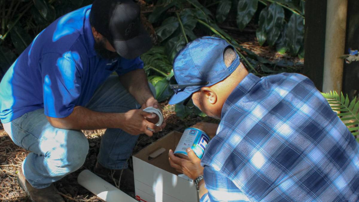 Volunteer plumbers travel to Volcano Village to install catchment diverters at 30 homes