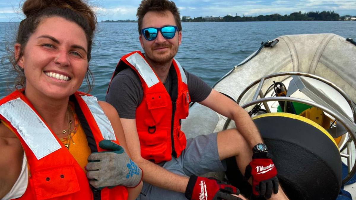 Cass Koby and Ethan Ward with Dewy the buoy in Hilo Bay. (Photo credit: PacIOOS)
