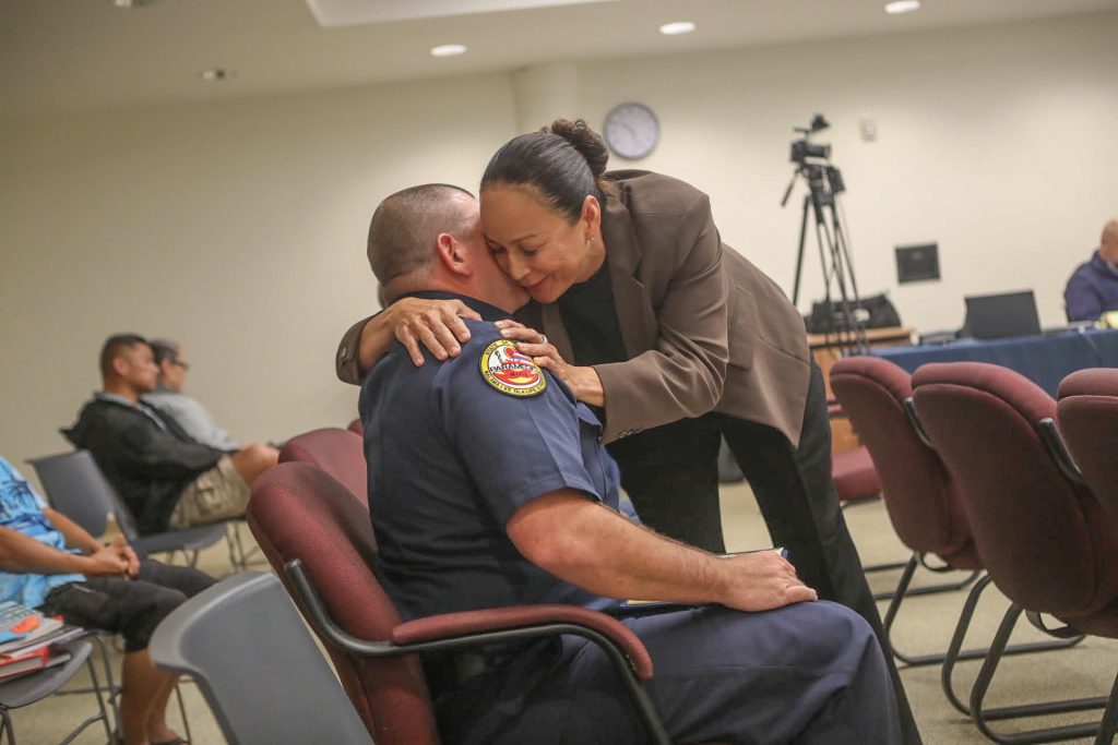 Fire chief finalist Melanie Keolanui, a battalion chief overseeing operations at the Hawaiʻi Fire Department, hugs Daniel Volpe after he was selected as the new fire chief on Oct. 22, 2026, in Hilo. (Kelsey Walling/Big Island Now)