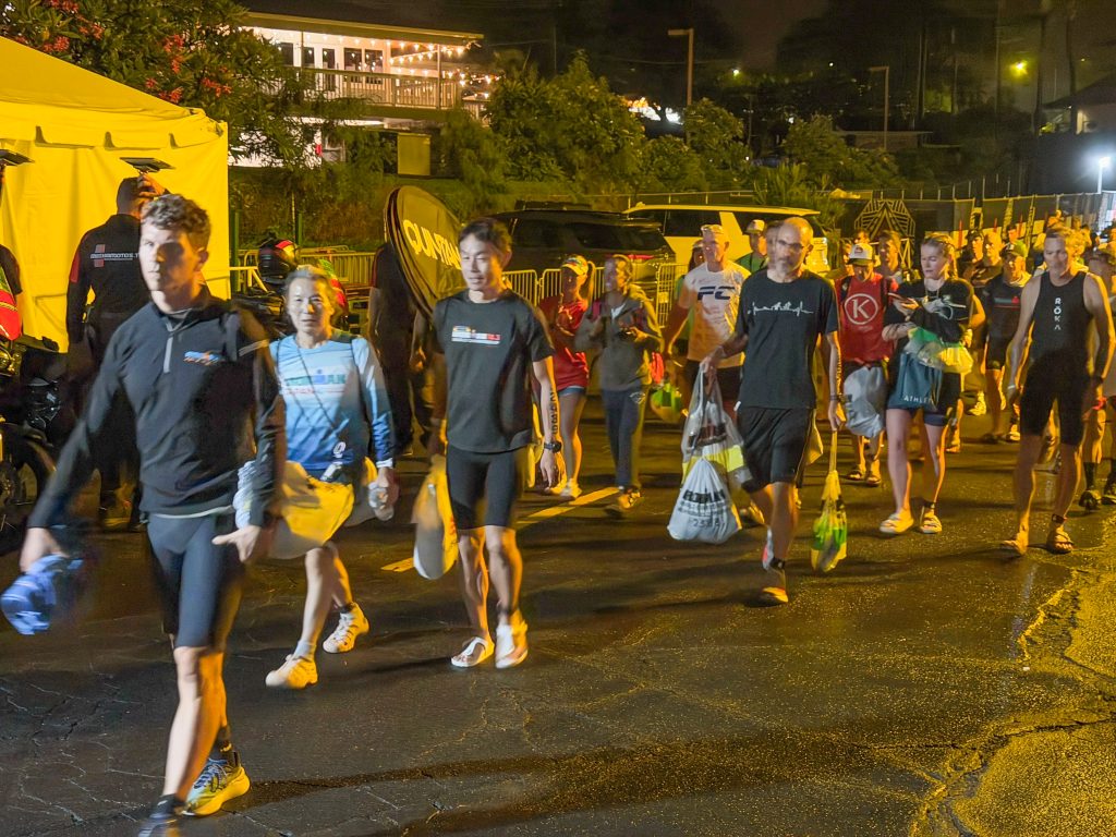 Athletes arrive a couple of hours before the start of the Ironman World Championship in Kailua-Kona on Oct. 10, 2026. (Tiffany DeMasters/Big Island Now)