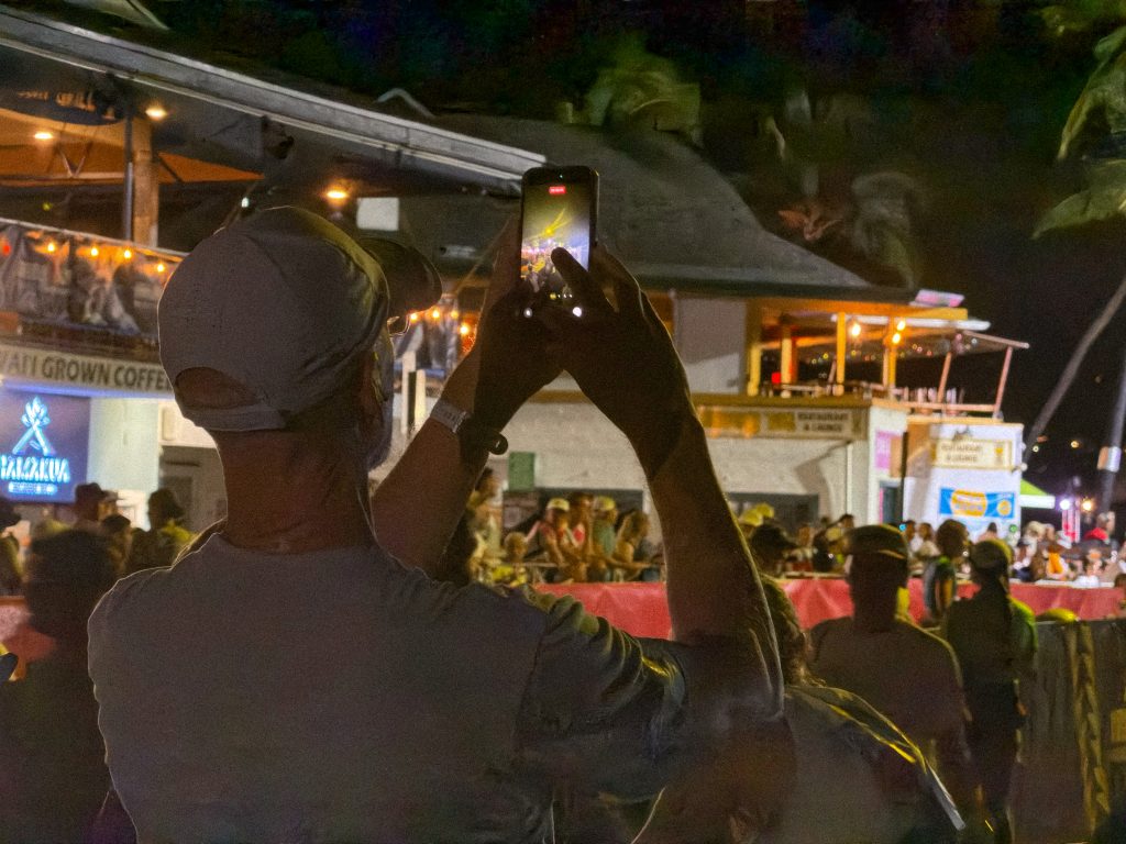 A spectator captures the pre race activity before the start of the Ironman World Championship on Oct. 10, 2026. (Tiffany DeMasters/Big Island Now)