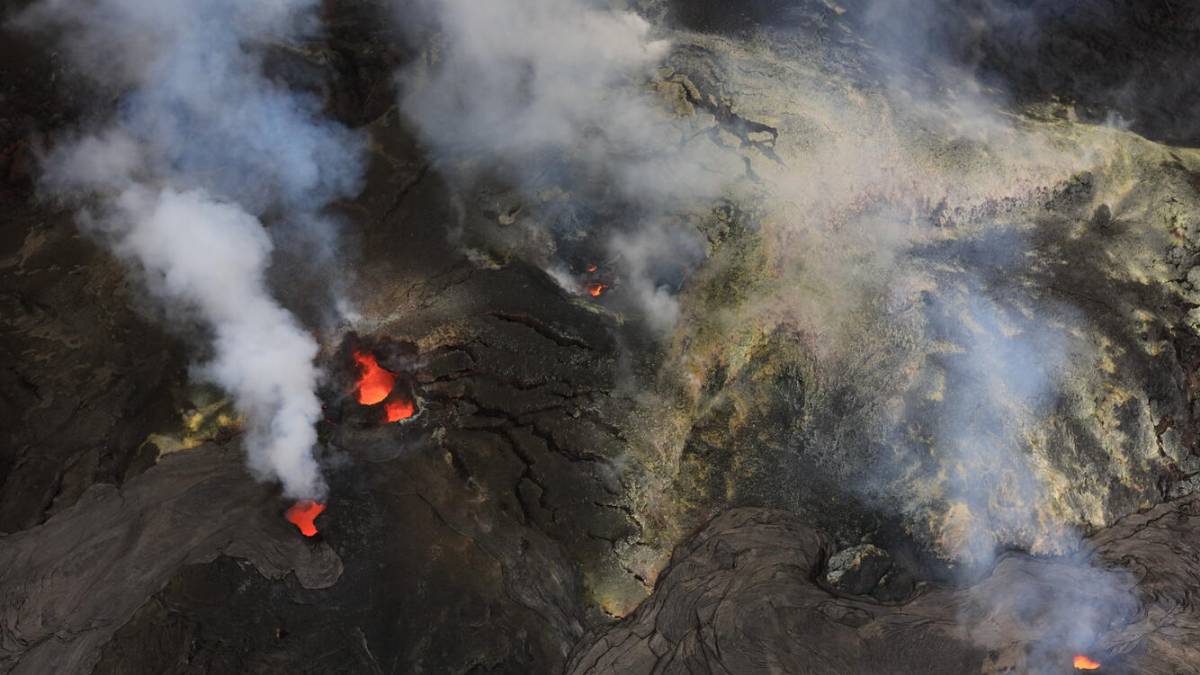 Aerial view of the north (bottom right of the photo), south (left side), and west (upper middle) vents in Halema‘uma‘u at the summit of Kīlauea on the morning of Oct. 1, 2026. All three vents were strongly glowing during the overflight, with lava seen at about 100 ft (30 m) down in the vent conduit. (Photo Credit: D. Downs/U.S. Geological Survey)