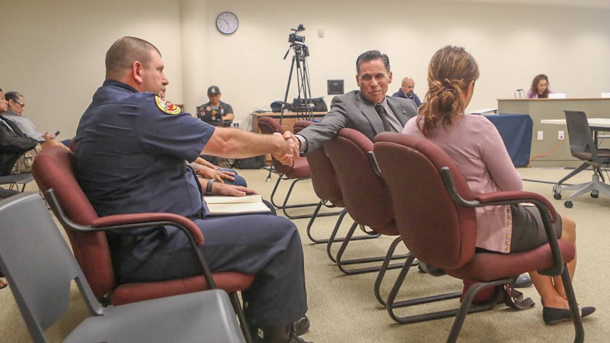 Fire chief finalist Garrett Kim (right) congratulates acting chief Daniel Volpe after it was announced that the Fire Commission had selected Volpe as the new chief on Oct. 22, 2026, in Hilo. (Kelsey Walling/Big Island Now)